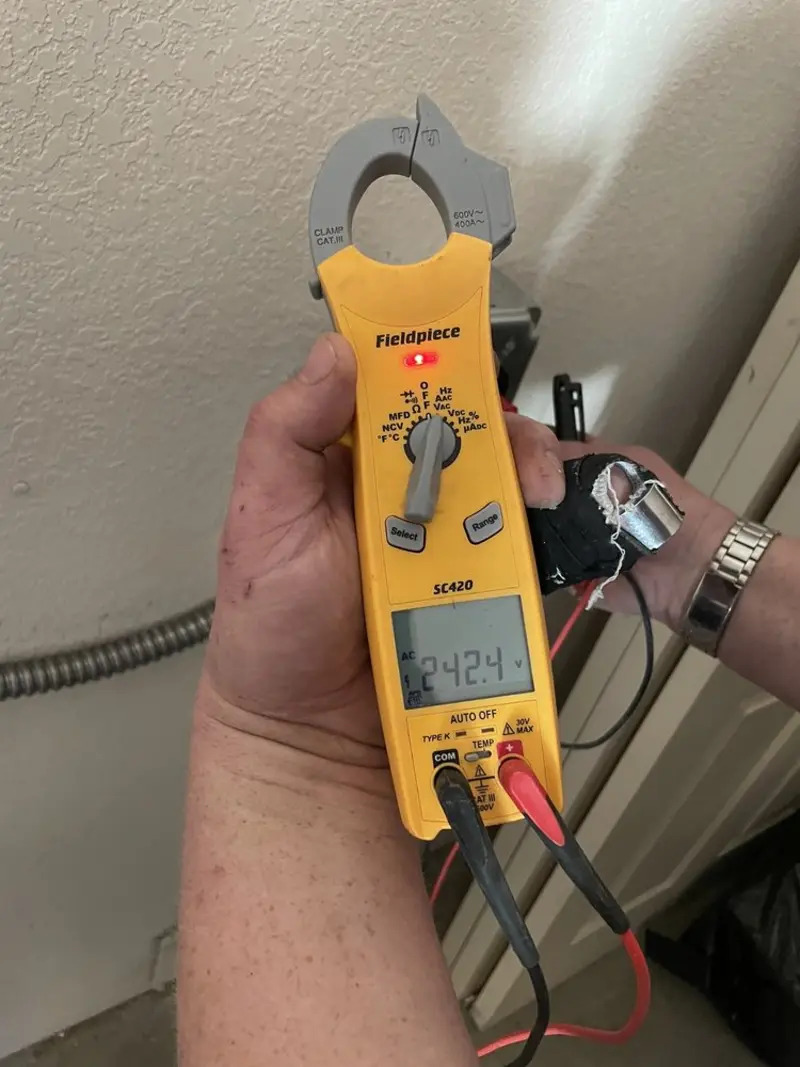 Voltage testing with clamp meter during Ceiling Fan Installation in Cherryville